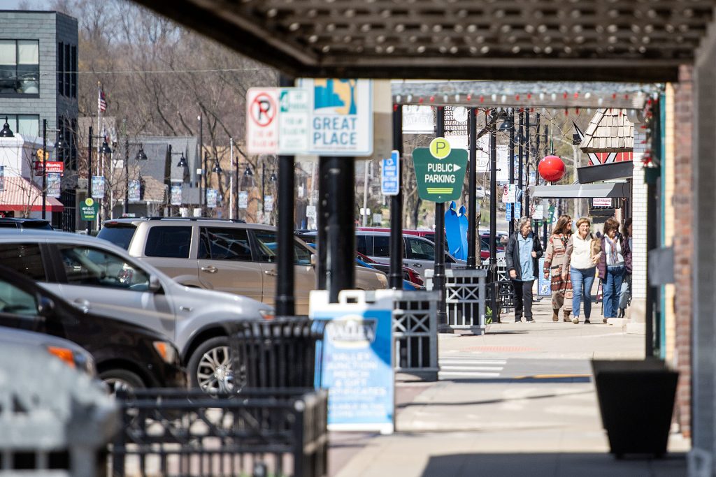 Pedestrians walk near stores and restaurants Tuesday, April 8, 2025, in West Des Moines, Iowa. Angela Major/WPR