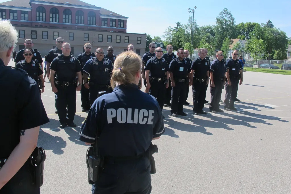 Police officers from the 5th District stand at attention during roll call. Republican legislators are proposing new legislation that adds requirements regarding school resource officers at Milwaukee Public Schools. (NNS file photo)