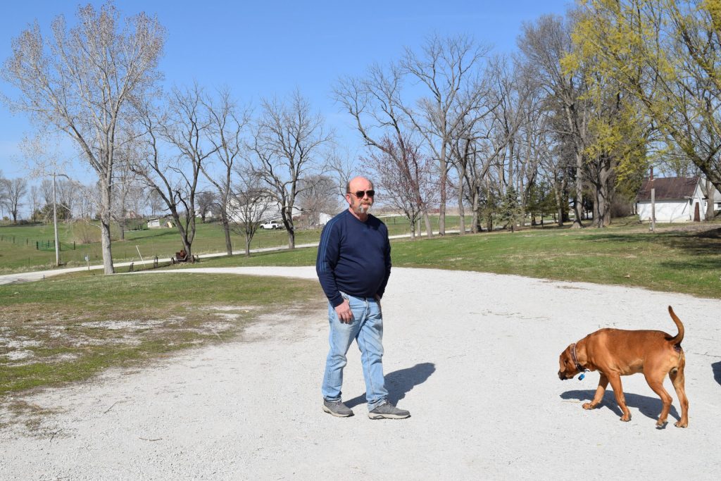 David Roach, a 62-year-old veteran, stands on his family farm in Cumming, Iowa. A data center campus will soon be built next to his home. Evan Casey/WPR