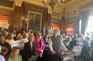 Robert Kraig of Citizen Action at the podium in the Senate parlor in the Wisconsin State Capitol on Tuesday, May 27 , surrounded by representatives of other grassroots groups | Ruth Conniff/Wisconsin Examiner