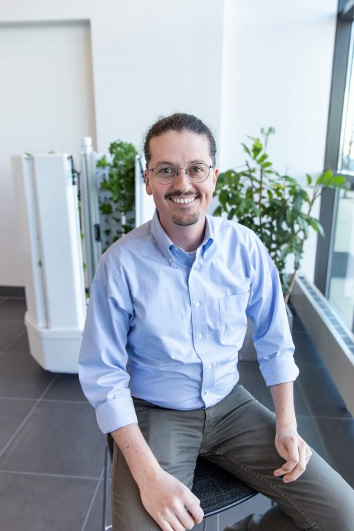 Fork Farms CEO and cofounder Alex Tyink. A Flex Farm sits behind him. Photo courtesy Fork Farms