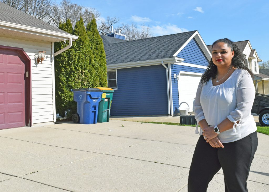 Brianna Allen Kaiser stands in front of her home near the South Oak Creek coal plant owned by We Energies. She opposes the utility’s plan to build a roughly $1.2 billion gas plant to meet growing power demand that’s largely driven by data centers. Evan Casey/WPR