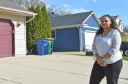 Brianna Allen Kaiser stands in front of her home near the South Oak Creek coal plant owned by We Energies. She opposes the utility’s plan to build a roughly $1.2 billion gas plant to meet growing power demand that’s largely driven by data centers. Evan Casey/WPR