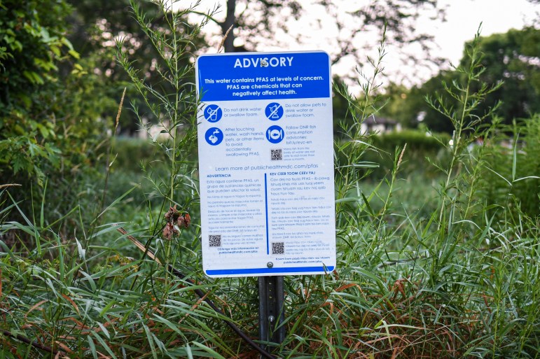 A sign warning of PFAS risks in Starkweather Creek in Madison, Wis., is posted along the creek at McCormick Park on July 20, 2021. Starkweather Creek is contaminated with PFAS, a group of human-made “forever chemicals” that accumulate in the body and persist in the environment without fully breaking down. Research has linked the substances to low birth weights, immune system challenges, thyroid problems, certain cancers and more. Isaac Wasserman/Wisconsin Watch