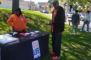Members of 414LIFE distribute information during a community popup on the North Side. (Photo by Edgar Mendez/NNS)
