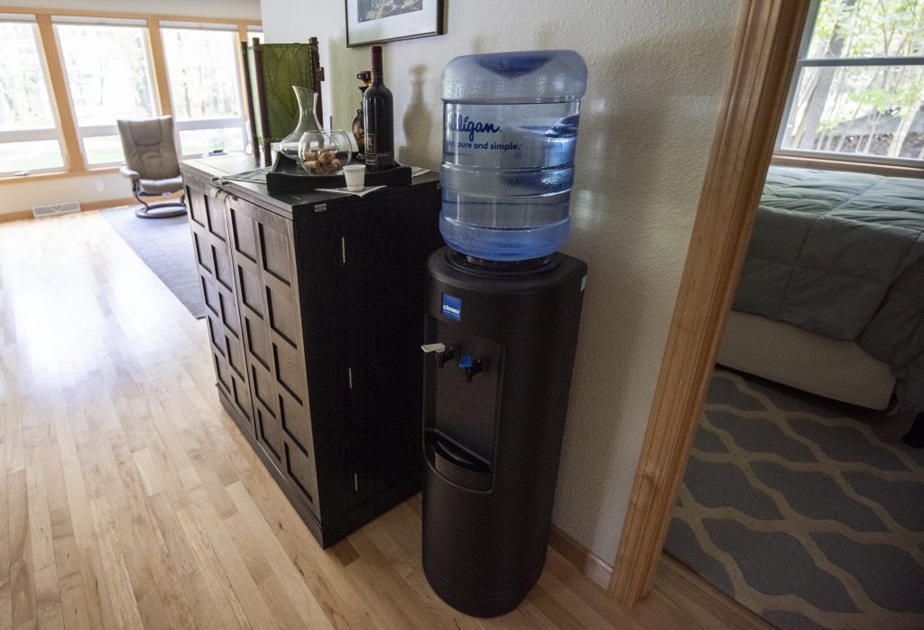 Jeff Lamont has a water dispenser in his Peshtigo, Wis., home due to PFAS contamination in the tap water. Angela Major/WPR