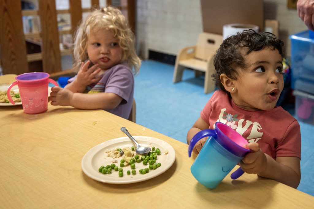 Two children eat lunch Monday, June 19, 2023, at Red Caboose in Madison, Wis. Angela Major/WPR