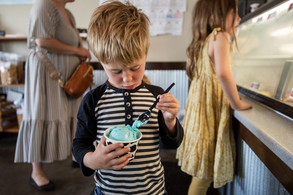 Four-year-old Abe Adelemyer looks at his blue moon ice cream Monday, May 12, 2025, at Sassy Cow Creamery in Columbus, Wis. Angela Major/WPR