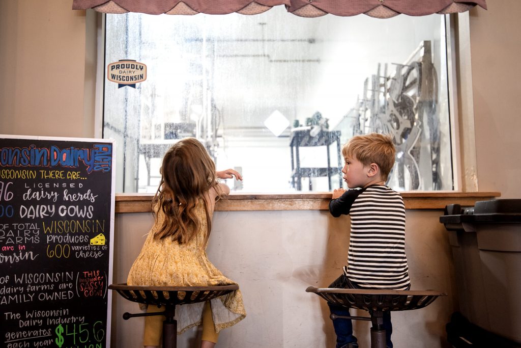 Kristina Leigh opens a freshly made pint of blue moon ice cream Monday, May 12, 2025, at Sassy Cow Creamery in Columbus, Wis. Angela Major/WPR