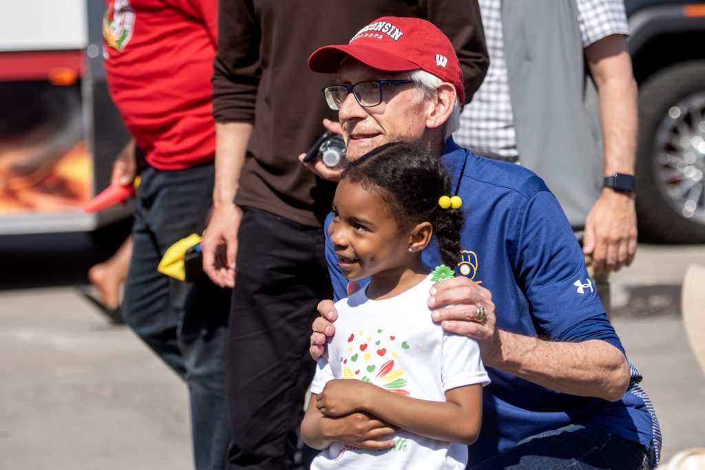 Gov. Tony Evers takes photos with attendees during the Juneteenth Jubilee Parade on Thursday, June 19, 2025, in Milwaukee, Wis. Angela Major/WPR