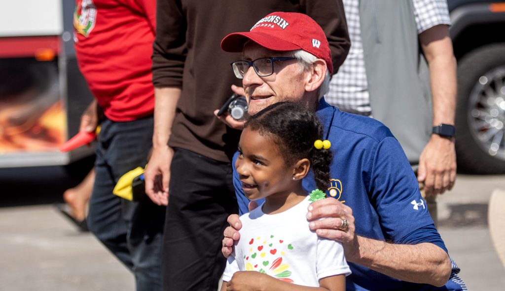 Gov. Tony Evers takes photos with attendees during the Juneteenth Jubilee Parade on Thursday, June 19, 2025, in Milwaukee, Wis. Angela Major/WPR