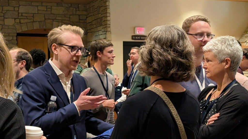 Devin Remiker speaking with delegates ahead of the chair vote on Sunday. (Photo by Baylor Spears/Wisconsin Examiner)