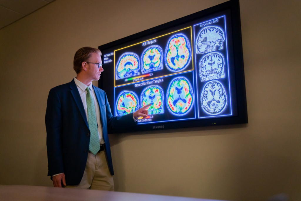 UW-Madison professor Sterling Johnson examines images from PET scans that may show markers in the brain that are associated with Alzheimer’s disease and other dementias. Photo courtesy UW-Madison