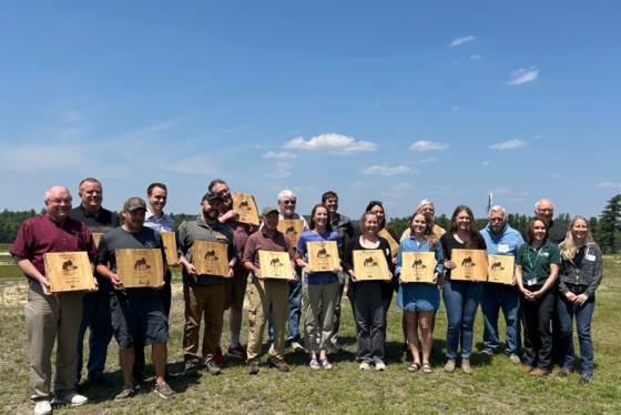 Recipients of the 2025 Invasive Species Action Awards stand with their plaques during the recognition ceremony held at the Wisconsin Cranberry Research Station on June 4. / Photo Credit: Wisconsin DNR