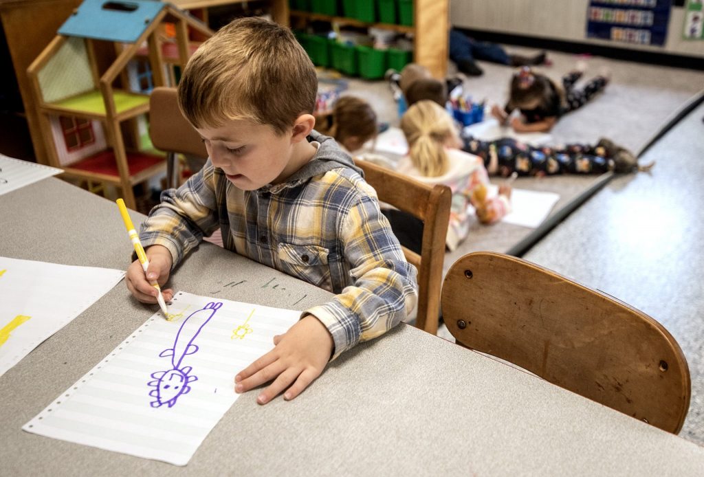 A preschool student draws in a classroom on Friday, Oct. 27, 2023, at Wee Care Child Center in Waupun, Wis. Angela Major/WPR