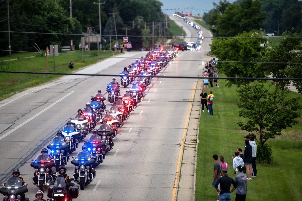 A funeral procession for Milwaukee Police Officer Kendall Corder drives past supporters Friday, July 11, 2025, in Brookfield, Wis. Angela Major/WPR