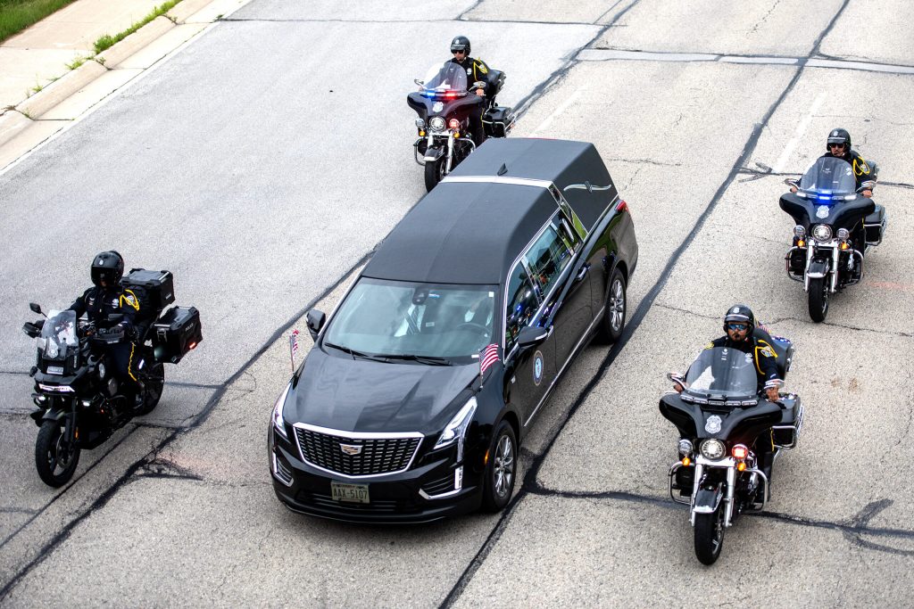 A funeral procession for Milwaukee Police Officer Kendall Corder drives to the cemetery where he will be laid to rest Friday, July 11, 2025, in Brookfield, Wis. Angela Major/WPR