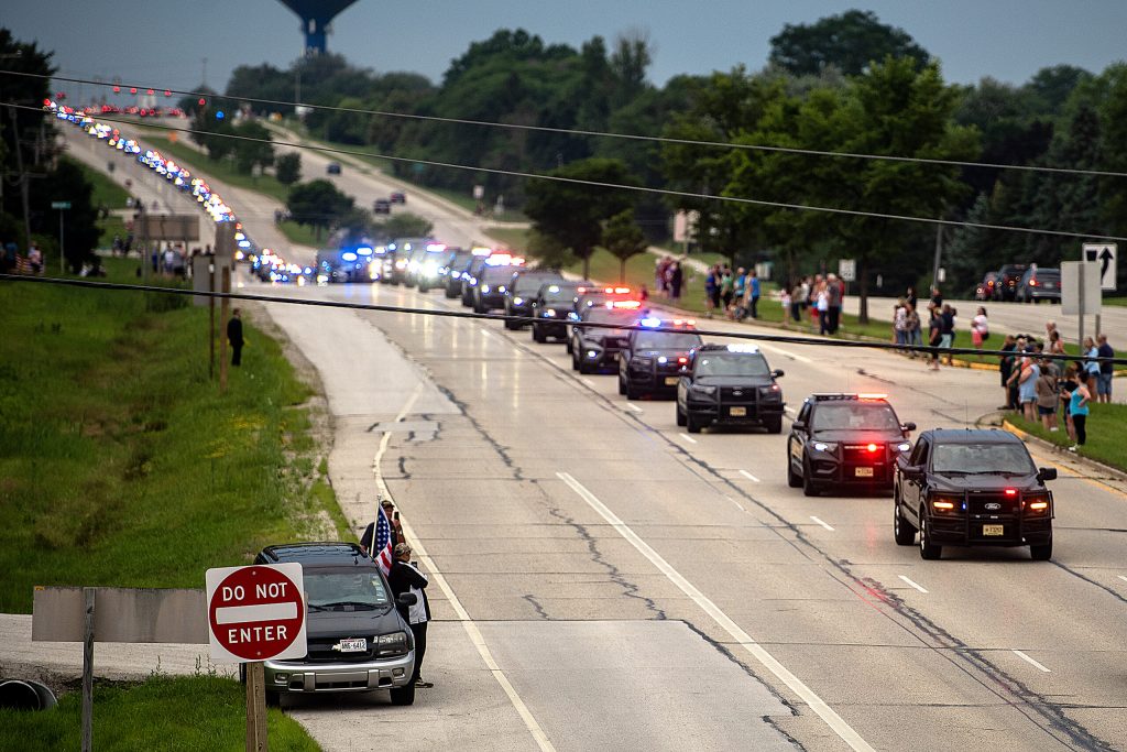 A funeral procession for Milwaukee Police Officer Kendall Corder drives past supporters Friday, July 11, 2025, in Brookfield, Wis. Angela Major/WPR