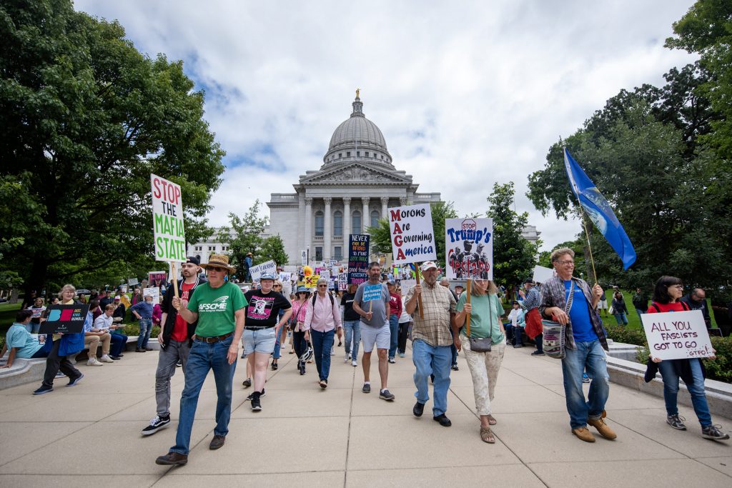 Protesters opposed to President Donald Trump march Thursday, July 17, 2025, at the Wisconsin State Capitol in Madison, Wis. Angela Major/WPR