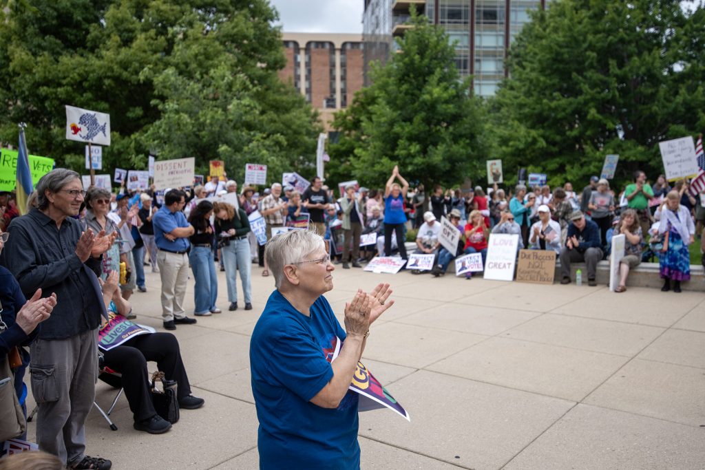 Protesters gathered in opposition to President Donald Trump applaud during a speech Thursday, July 17, 2025, at the Wisconsin State Capitol in Madison, Wis. Angela Major/WPR
