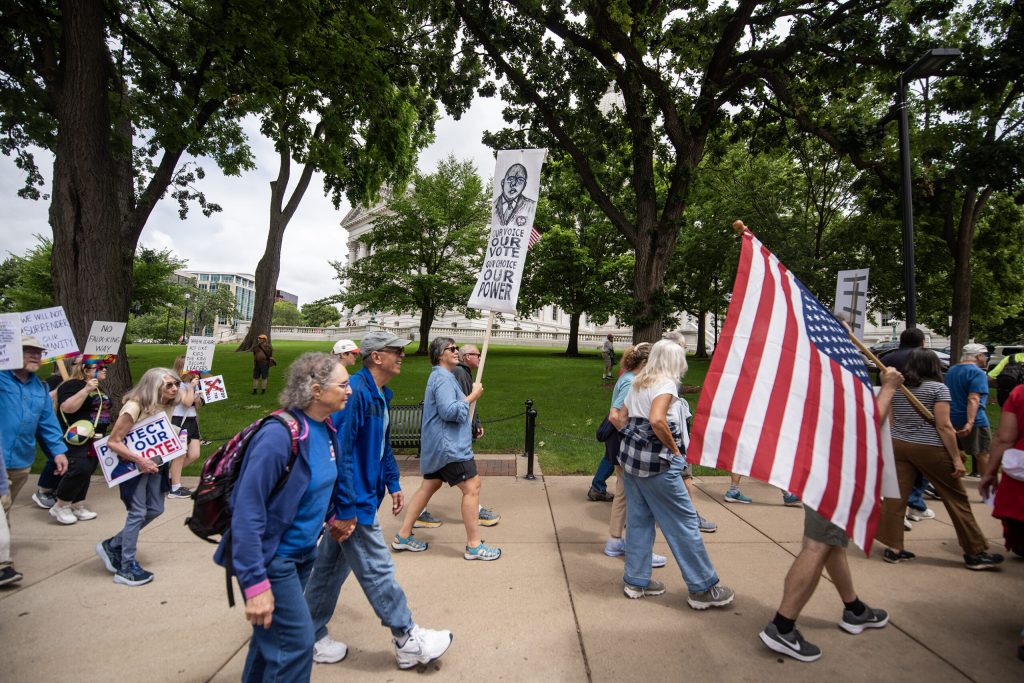 Protesters share an anti-Trump message as they march around the Wisconsin State Capitol on Thursday, July 17, 2025, in Madison, Wis. Angela Major/WPR