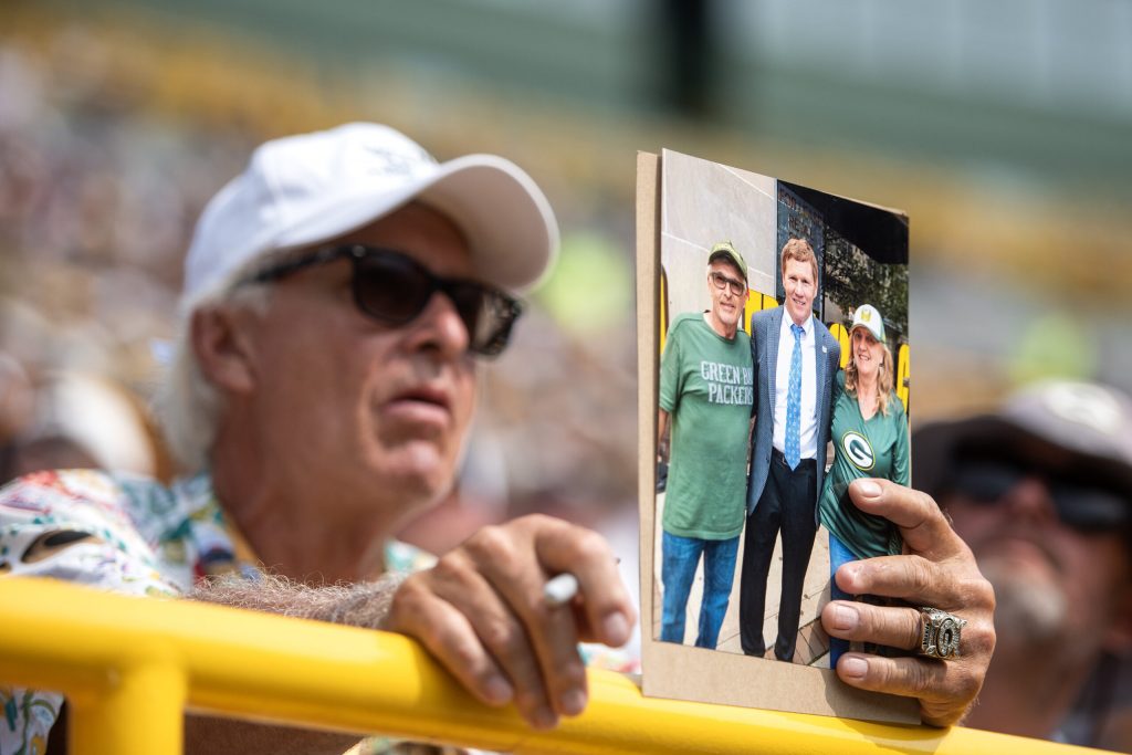 An attendee holds a photo of Green Bay Packers President and CEO Mark Murphy during the Green Bay Packers Annual Meeting of Shareholders on Friday, July 25, 2025, at Lambeau Field in Green Bay, Wis. Angela Major/WPR
