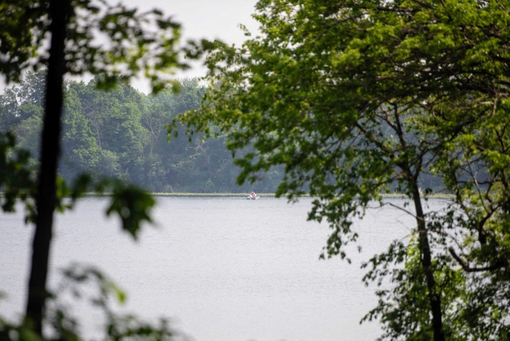 Smoke casts a haze in front of the trees that surround Storrs Lake on Wednesday, June 4, 2025, in Milton, Wis. Angela Major/WPR