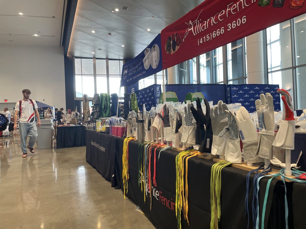 Vendors sell fencing gear at the USA Fencing National Championship in Milwaukee’s Baird Center on July 2, 2025. Nick Rommel/WPR