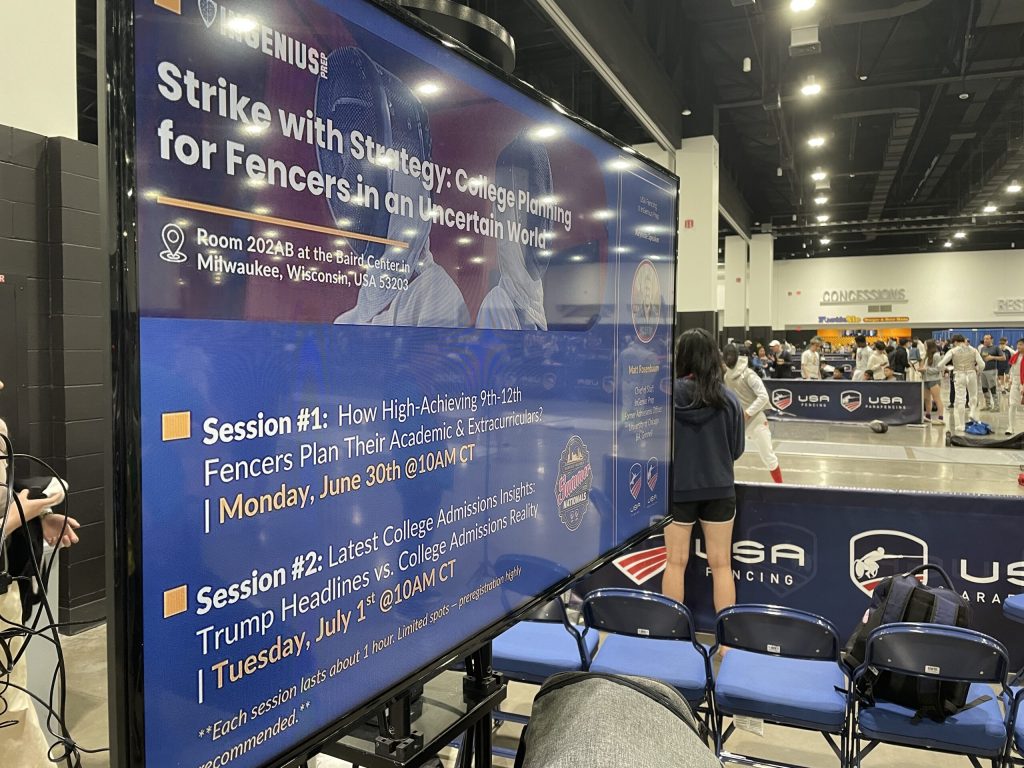 A screen advertises info sessions for tournament attendees at the USA Fencing National Championship in Milwaukee’s Baird Center on July 2, 2025. Nick Rommel/WPR