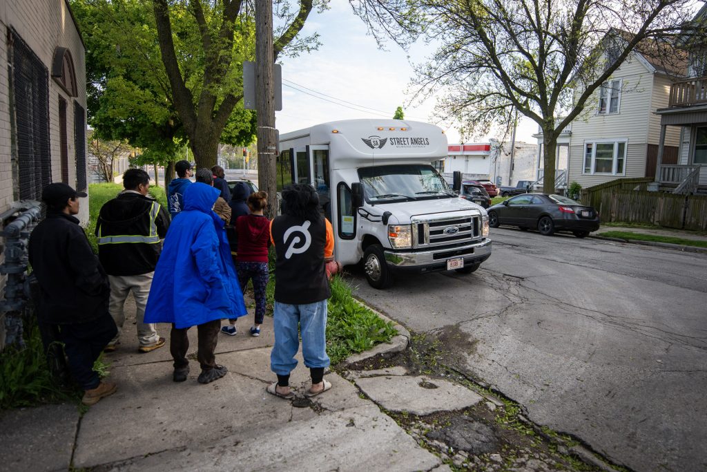 People wait for clothes, toiletries and other supplies from a Street Angels bus Thursday, May 9, 2024, in Milwaukee, Wis. Angela Major/WPR