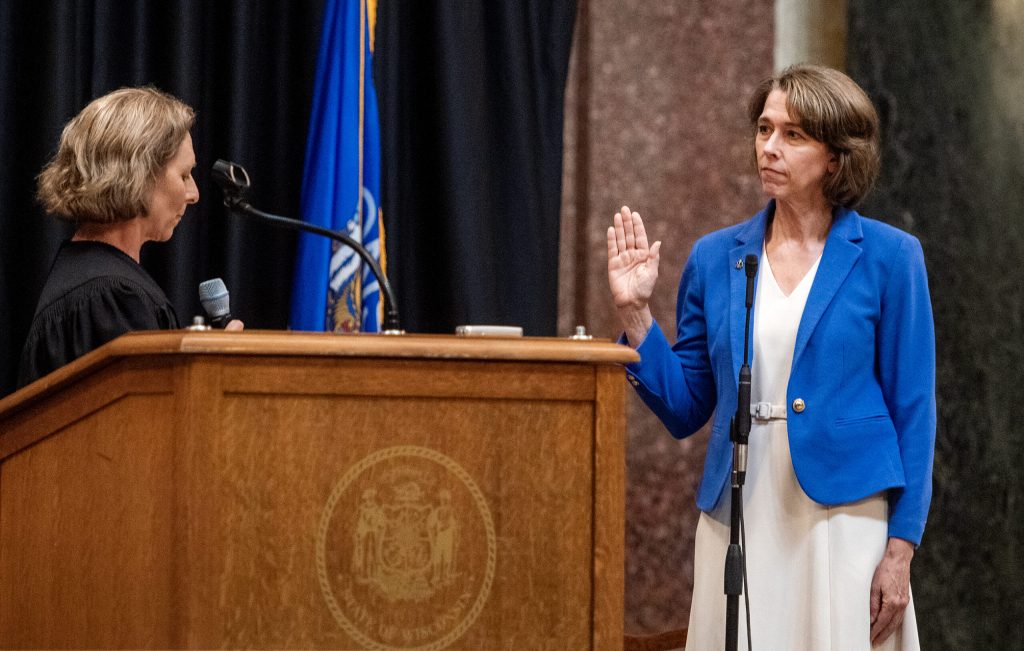 Susan Crawford, right, becomes a Wisconsin Supreme Court justice as Chief Justice Jill Karofsky, left, leads her in an oath Friday, Aug. 1, 2025, at the Wisconsin State Capitol in Madison, Wis. Angela Major/WPR