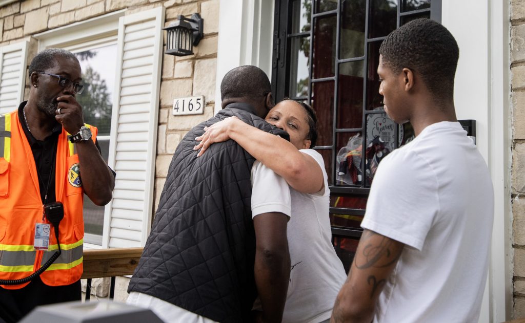 Milwaukee resident Collette Anderson hugs Milwaukee County Executive David Crowley as he visits her home in the wake of flooding throughout the city Tuesday, Aug. 12, 2025, in Milwaukee, Wis. Angela Major/WPR