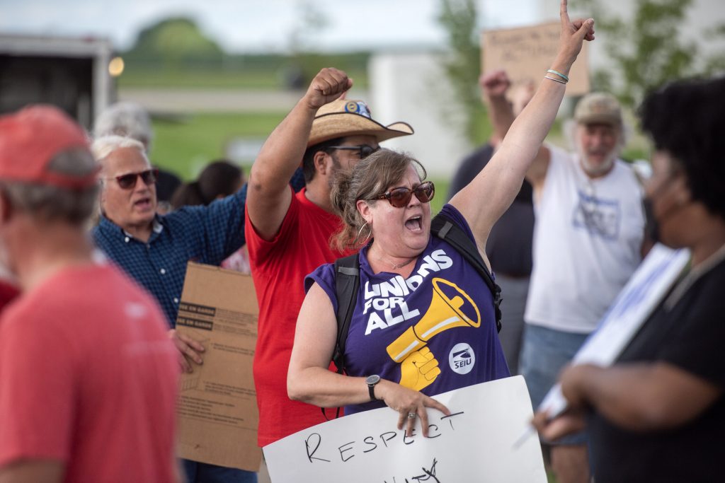 Attendees picket in support of striking workers Tuesday, Aug. 19, 2025, at W&W Dairy in Monroe, Wis. Angela Major/WPR