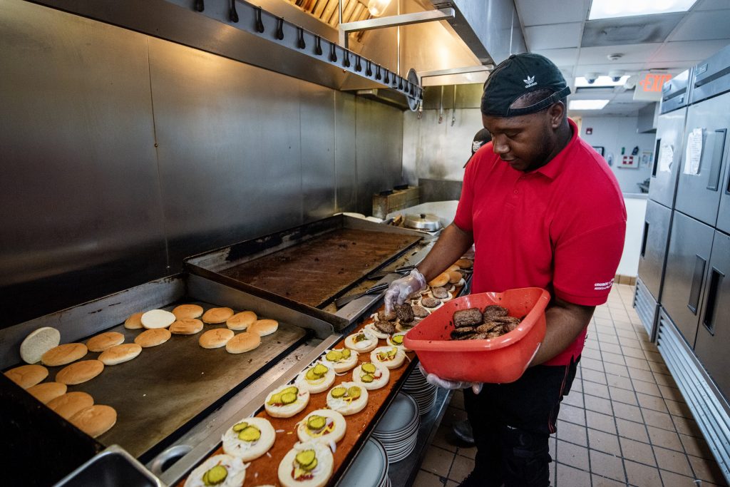 Workers prepare burgers for Brewers fans Wednesday, Aug. 20, 2025 at George Webb in Wauwatosa, Wis. Angela Major/WPR