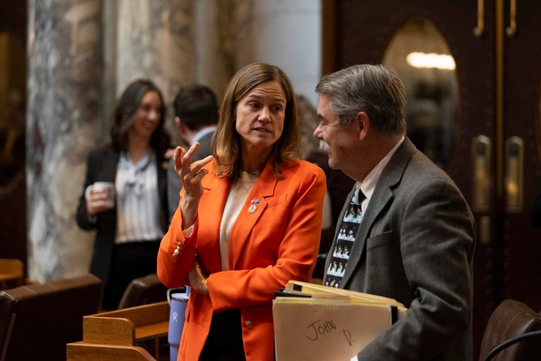 Rep. Deb Andraca, D-Whitefish Bay, left, talks to Rep. Joe Sheehan, D-Sheboygan, right, prior to the Wisconsin Assembly convening during a floor session Jan. 14, 2025, at the State Capitol in Madison, Wis. (Joe Timmerman / Wisconsin Watch)