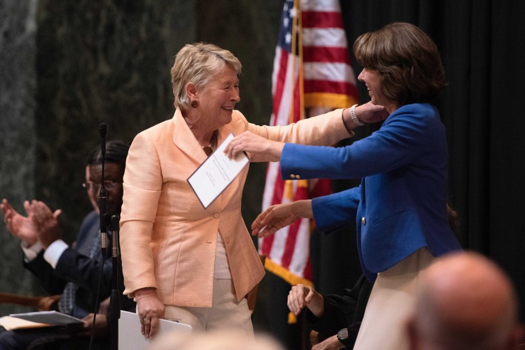 Retired Chief Justice Ann Walsh Bradley, left, embraces Justice-elect Susan Crawford, right, during Crawford’s investiture Friday, Aug. 1, 2025, at the Wisconsin State Capitol in Madison, Wis. Angela Major/WPR