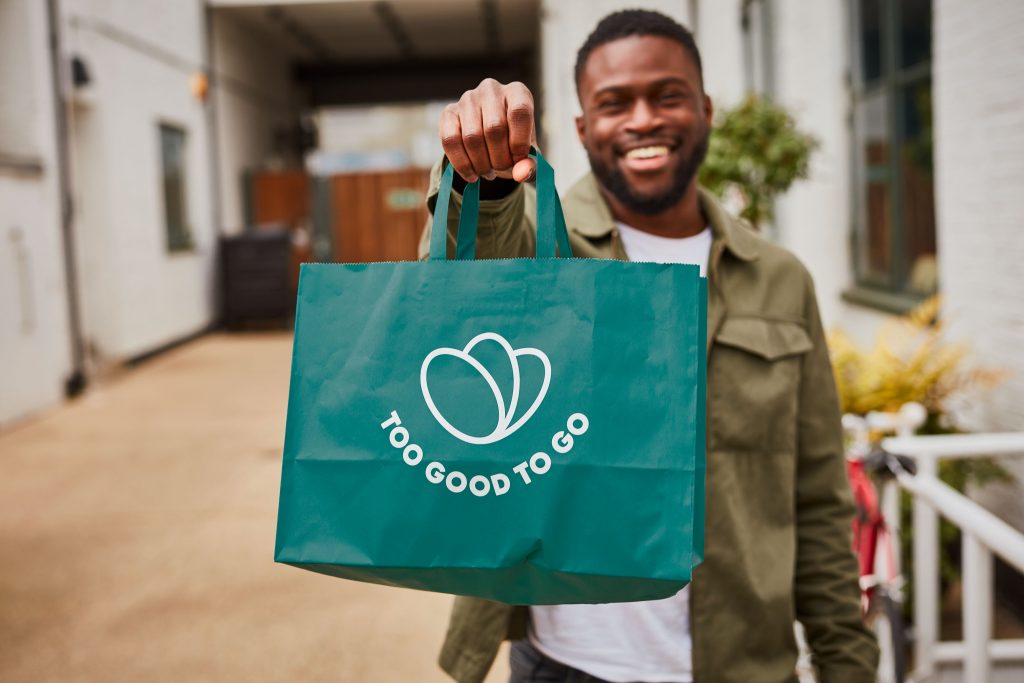 Customer holds "Surprise Bag." Photo courtesy of Too Good To Go.