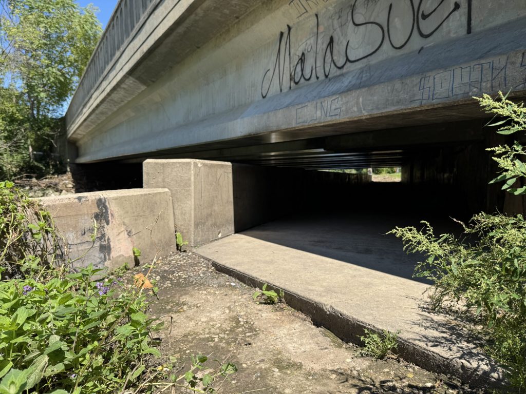 A homeless encampment next to Milwaukee’s Kinnickinnic River is seen here on Thursday, Aug. 21, 2025. Evan Casey/WPR