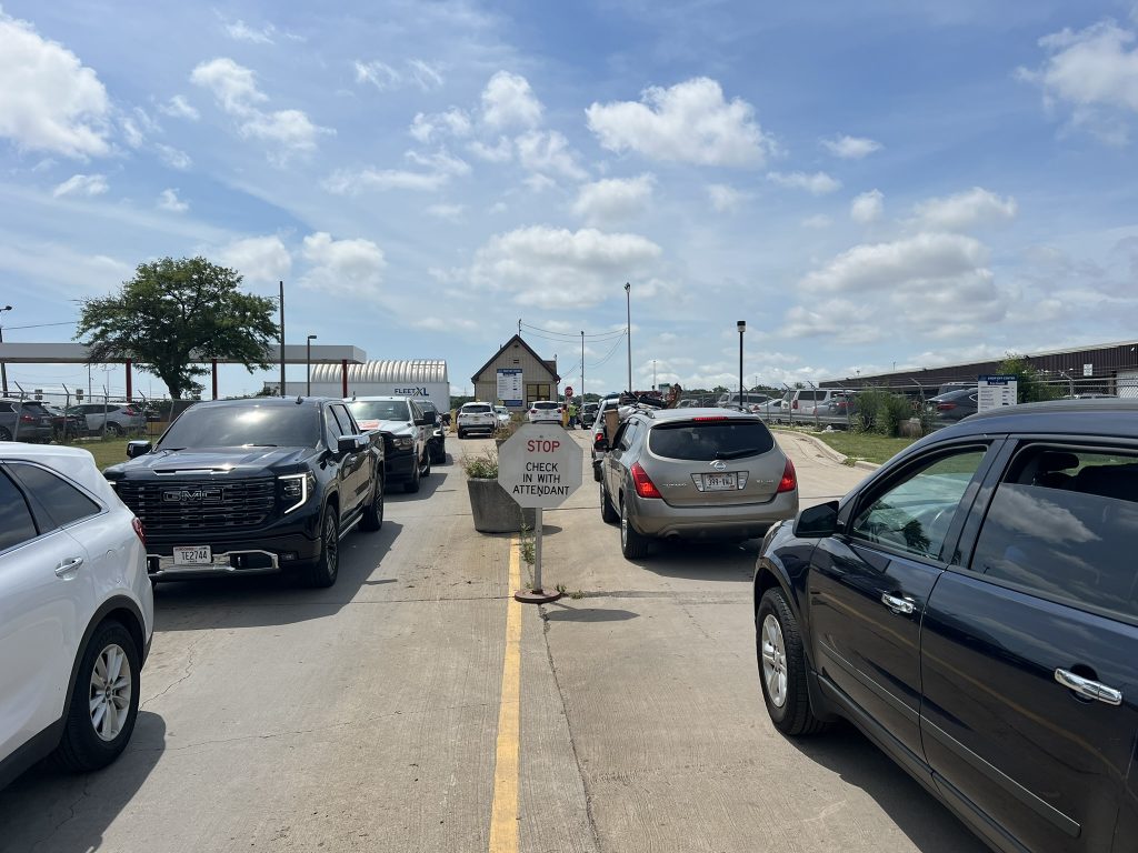 Lines of vehicles wait to get in and out of the South Drop-Off Center after a 1,000-year storm. Photo by Jeramey Jannene.