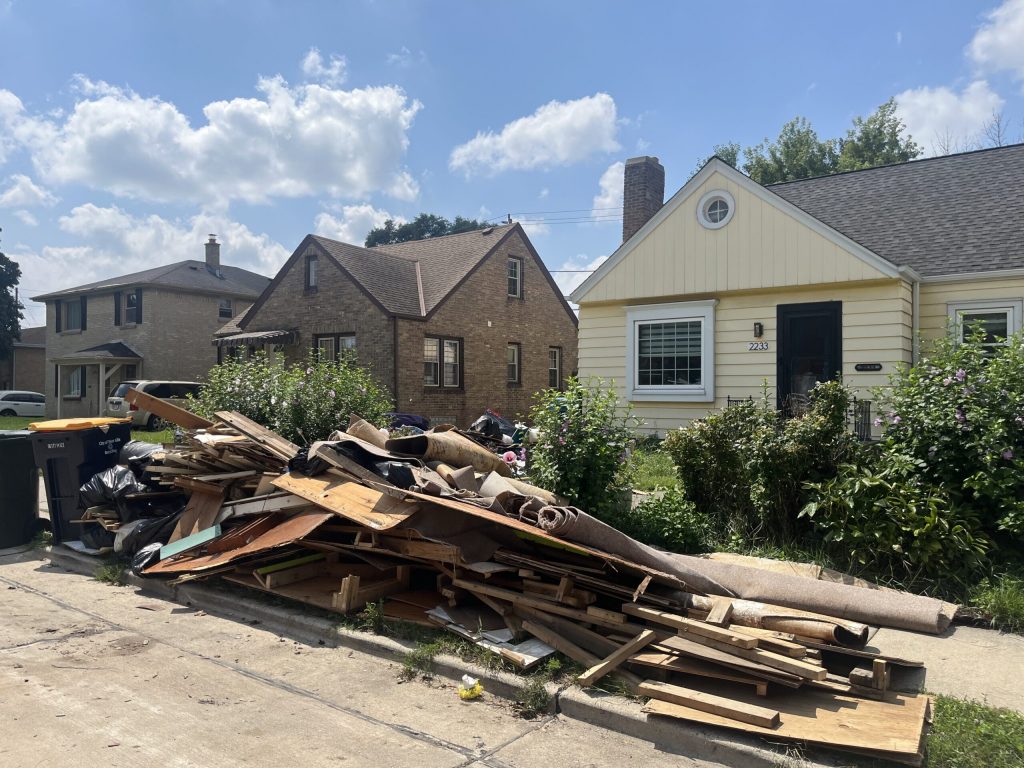 Occupants of homes in West Allis, Wis. are getting rid of items damaged from recent storms and flooding on Aug. 15, 2025. Corrinne Hess/WPR