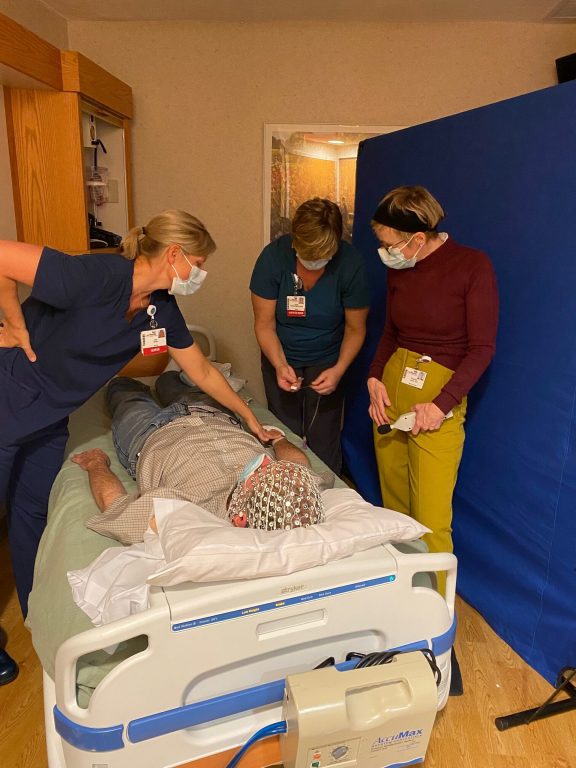 Psychiatrist Charles Raison wears an EEG cap while testing procedures with nurses at the UW-Madison Clinical Research Unit. His lab studies how consciousness plays a role in the therapeutic promise of psychedelics. Photo courtesy of the Raison Lab