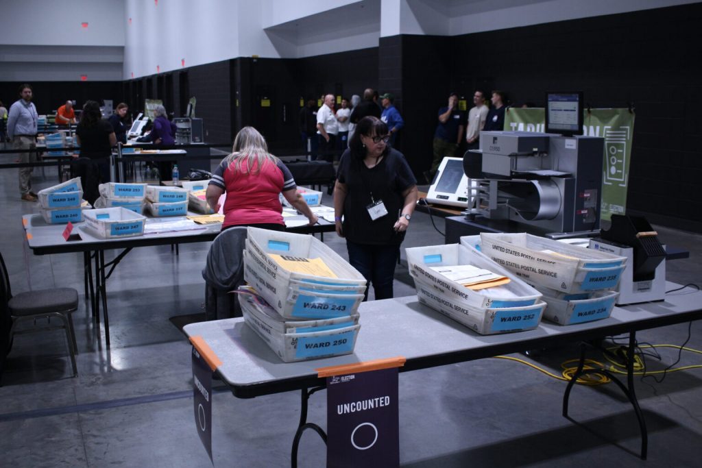 Boxes of ballots wait to be counted at Milwaukee’s central count on Election Day 2024. (Henry Redman | Wisconsin Examiner)
