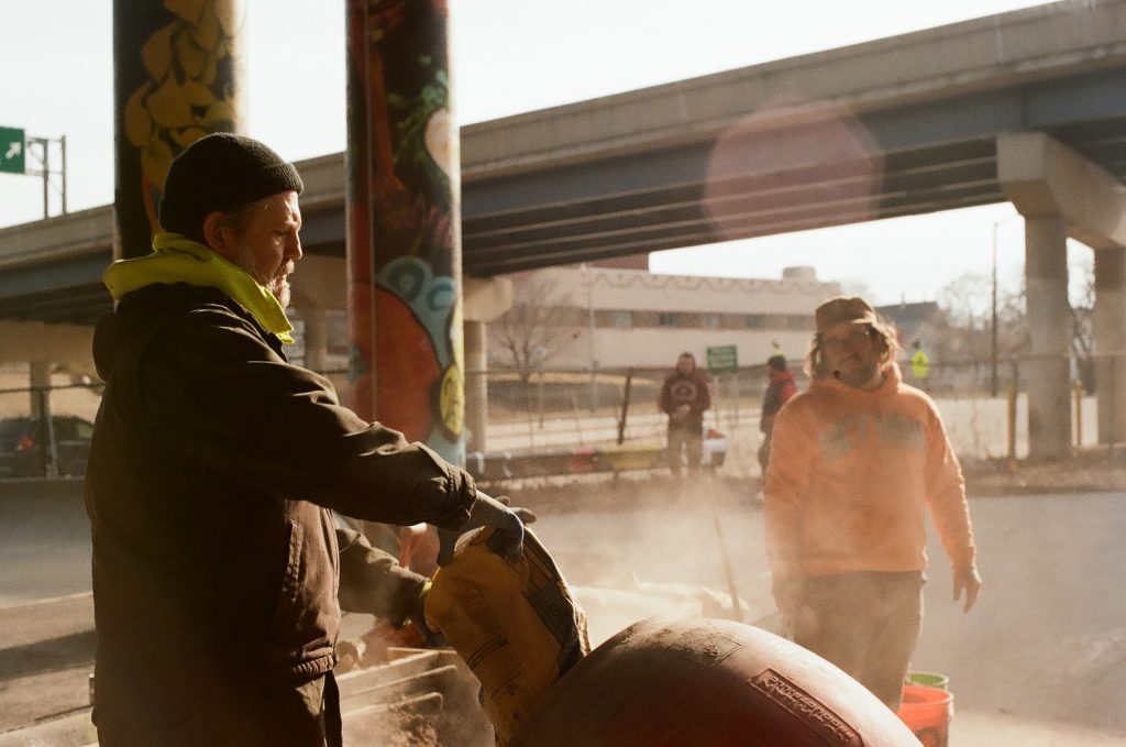 Aaron Polansky pours cement to construct the National DIY Skatepark underneath a freeway in Milwaukee’s Walker’s Point neighborhood. Photo courtesy of Emmy Yates