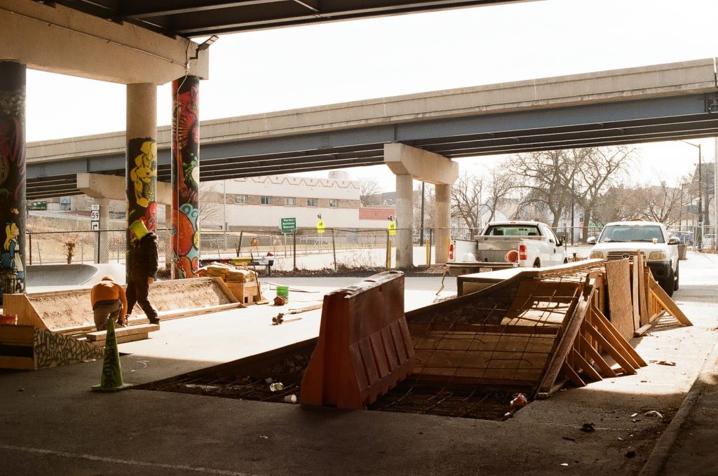 Skate ramps stand partially constructed underneath a freeway in Milwaukee’s Walker’s Point neighborhood, at the site of National DIY Skatepark. Photo courtesy of Emmy Yates
