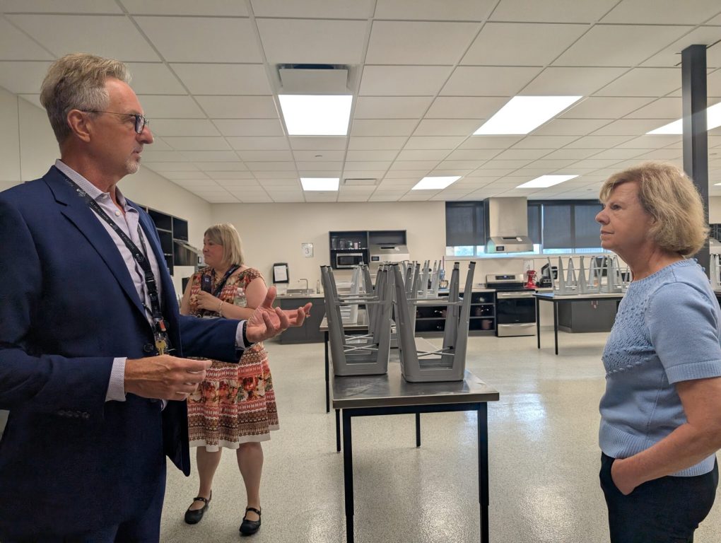 “One of my most popular classes is our cooking classes, right, and kids get to learn basic life skills, and then, they actually do cooking for the school,” Principal Mathew Thompson told Baldwin before entering one of the classrooms. (Photo by Baylor Spears/Wisconsin Examiner)