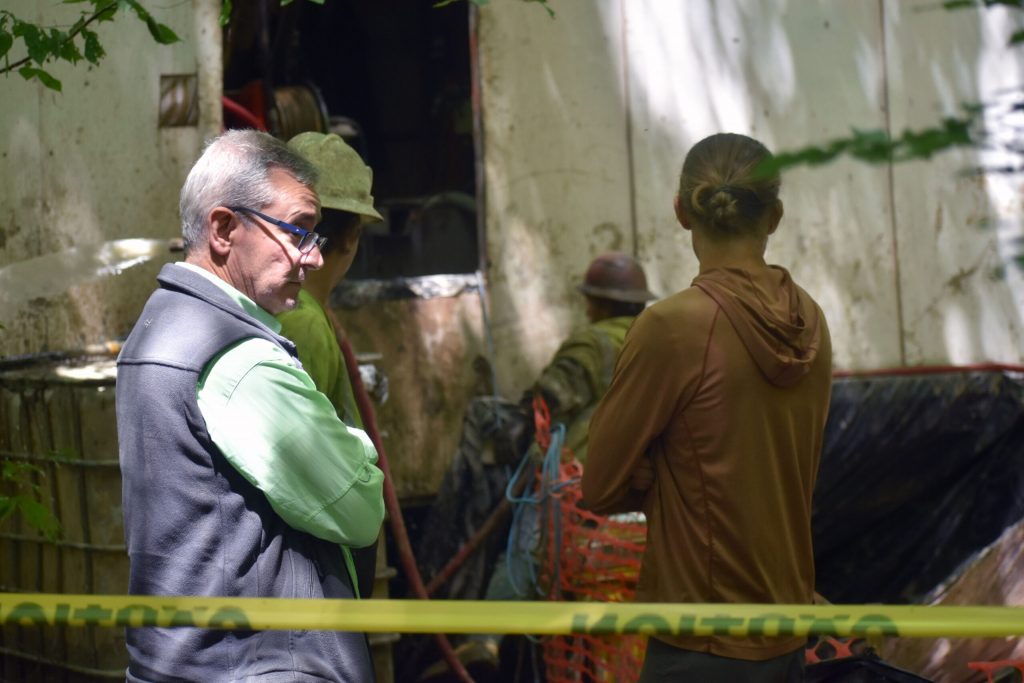 Steve Donohue, a director on the mining company’s board, observes activities at a drill site in the Chequamegon-Nicolet National Forest on July 17, 2025. Danielle Kaeding/WPR