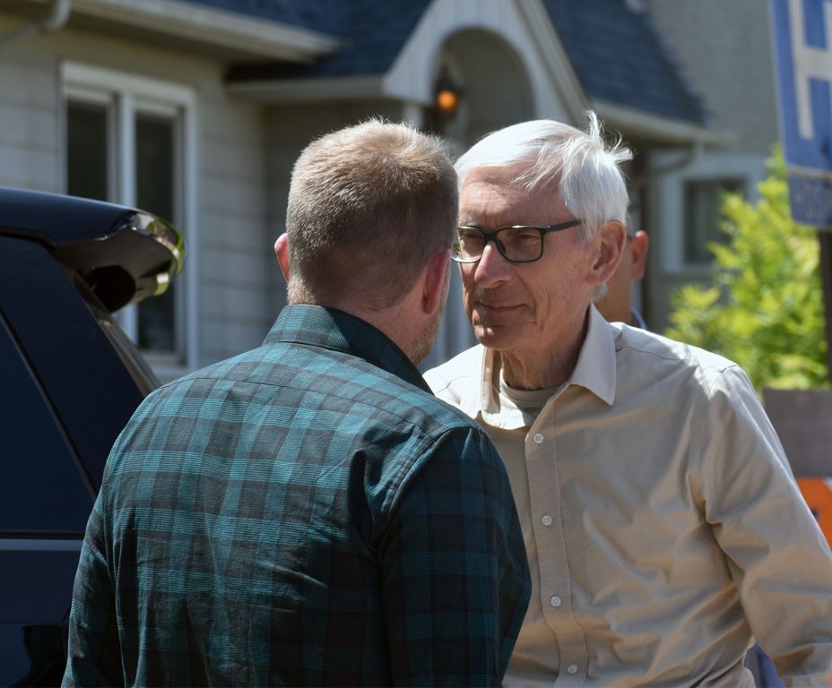 Superior Mayor Jim Paine and Gov. Tony Evers greet each other on Hammond Avenue in Superior where the city and Superior’s privately-owned water utility are partnering to replace lead pipes. Danielle Kaeding/WPR