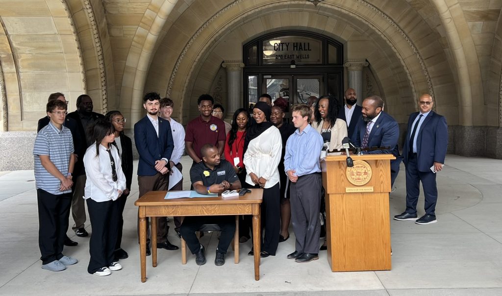 Mayor Cavalier Johnson signs the 2024-2025 Youth Council CDBG recommendations. Photo by Jeramey Jannene.
