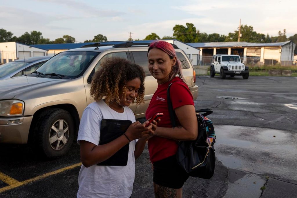 Tracy Germait, right, who has been waiting more than two years for a public defender, laughs with her daughter, Isis, 11, after leading a Cocaine Anonymous meeting Aug. 12, 2025, at MannaFest Church in Green Bay, Wis. (Joe Timmerman / Wisconsin Watch)