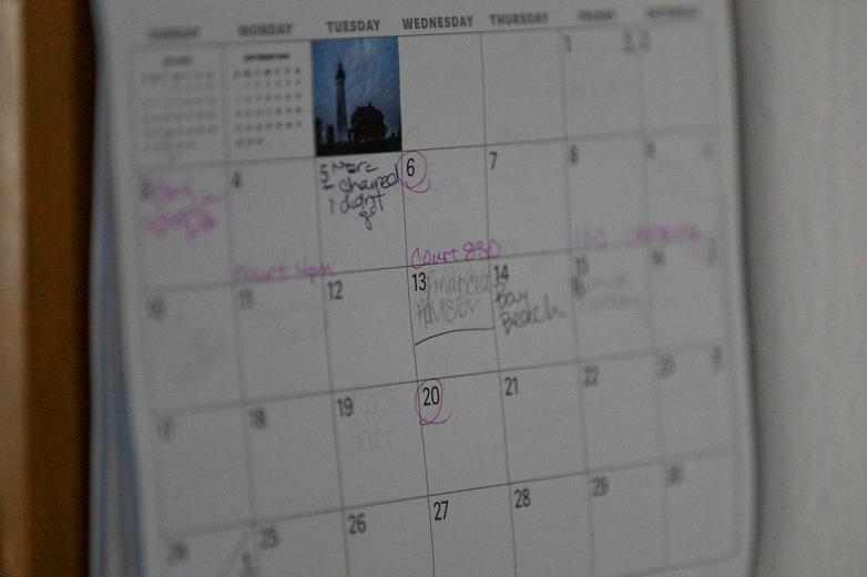 A calendar hangs on the wall at Tracy Germait’s transitional housing unit Aug. 12, 2025, in Green Bay, Wis. (Joe Timmerman / Wisconsin Watch)
